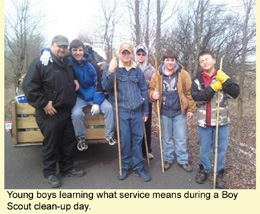 Young boys learning what service means during a Boy Scout clean-up day
